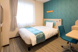 Postel nebo postele na pokoji v ubytování Comfort Hotel Miyazaki