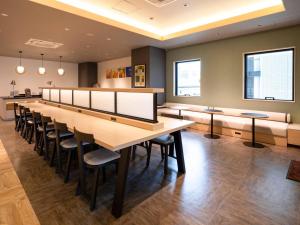 a large room with a long table and chairs at Comfort Hotel Mito in Mito