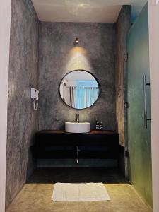 a bathroom with a sink and a mirror at Beverly Beach Mirissa in Mirissa