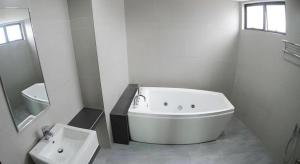 a white bathroom with a tub and a sink at Star-Well hotel in Kuala Lipis +49 photos