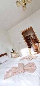 a bedroom with a white bed with a ceiling at Casa Craiului in Zărneşti