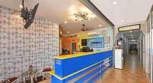 a restaurant with a blue counter in a room at Hotel O Ummul Motel in Arau
