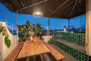 a table in a room with a view of the city at Urban Horizon Boutique Suites in Hanoi