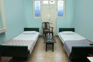 A bed or beds in a room at Solanki Guest House