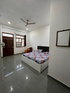 a bedroom with a bed in the middle of a room at Kamal Kishori Dham in Barsāna