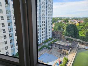 a view of a pool from a window in a building at Avida Abreeza 1bedroom with balcony in Davao City