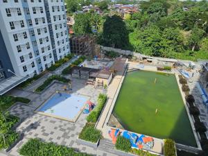 an aerial view of a large pool with a water park at Avida Abreeza 1bedroom with balcony in Davao City