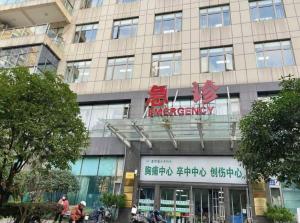 a building with a sign on the front of it at Pai Hotel Guiyang Daximen West Zhongshan Metro Station in Guiyang