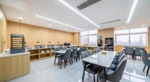 a conference room with tables and chairs in a building at GreenTree Inn Suzhou North Zhongshan Road Weiye Yingchun Plaza Business Hotel in Suzhou
