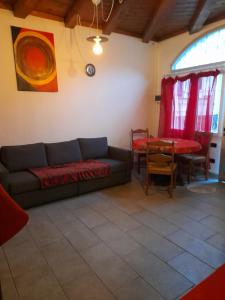 a living room with a couch and a table at La casetta di Sofia in Torino