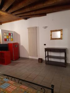 a living room with a red refrigerator and a table at La casetta di Sofia in Torino +7 photos