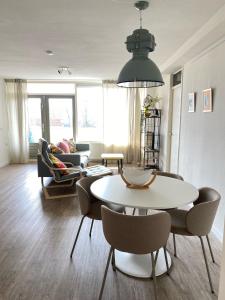 a living room with a table and chairs at Residenz Polderblick Burgerbrug in Burgerbrug