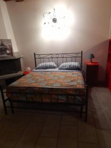 a bedroom with a bed and a light on the wall at La casetta di Sofia in Torino