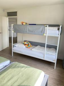 two bunk beds in a small room withthritisthritisthritisbestosbestosbestosbestosbestos at Residenz Polderblick Burgerbrug in Burgerbrug +44 photos