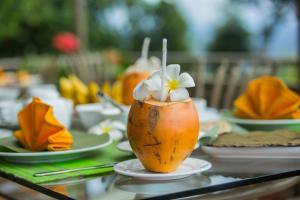a table topped with a pineapple with flowers in it at Sky Pavilion in Kandy