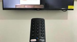 a remote control sitting in front of a television at Dehome near Pakuwon Mall (Syariah) in Surabaya
