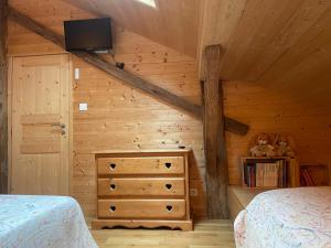 a bedroom with a bed and a dresser with a tv at Au Solé in Basse-sur-le-Rupt