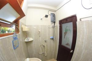 a bathroom with a shower and a toilet at Grindlays Villa in Weligama