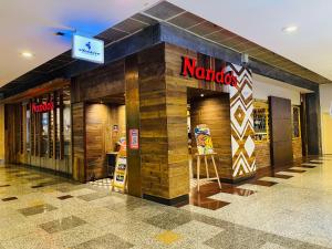 a karma store with a sign on the front of it at Max Suites At Barjaya Times Square Kl in Kuala Lumpur +60 photos