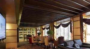 a dining room with a table and chairs and a large window at Ambassador Hotel in Shenzhen