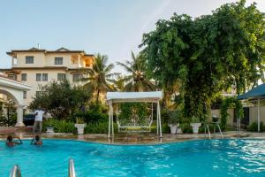 a swimming pool with a gazebo in a hotel at Cosy 1 BR with Swimming Pool & Garden & 25 Mins to Airport - C04 in Mombasa