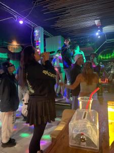 a group of people dancing at a party at Poppy hostel in Pai