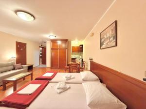 a living room with a large bed in a room at Beachfront Apartments Oaza in Petrovac na Moru