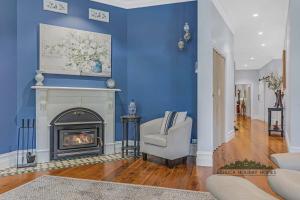 a living room with a blue wall with a fireplace at Trebor on Dickson in Echuca +11 photos