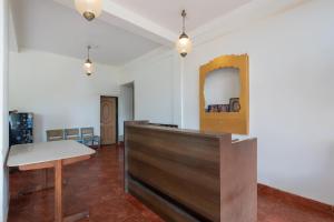a room with a table and a mirror on the wall at Hotel O Oragadam Industrial Estates Chennai Formerly SSM Rooms in Oragadam