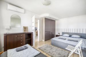 a bedroom with a bed and a dresser and a mirror at Apartament Centrum in Warsaw