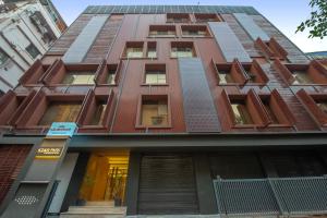 a tall red building with windows at Kzar Park in Kolkata +14 photos