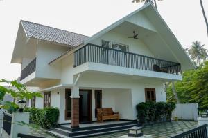 a house with a pitched roof at Paradise Riviera in Ernakulam