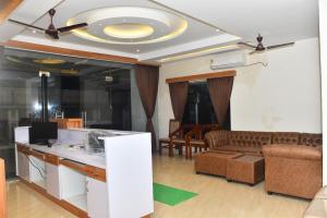 a living room with a couch and a table at Hotel MG Grand in Rāmeswaram