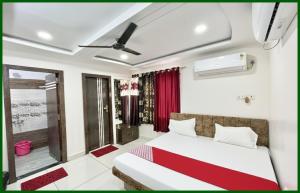 a bedroom with a bed and a window at Mahakal Temple Railway station, Salimar Palace - Fully Air conditioned Rooms with Wifi And Parking, , BEST HOTEL IN UJJAIN in Ujjain