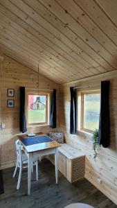 a wooden room with a table in a cabin at Webers Tiny House in Rentjärn