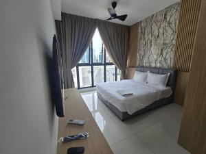 a bedroom with a bed and a tv and a window at City centre Majestice Suite KLCC in Kuala Lumpur +24 photos