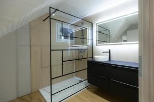 a bathroom with a sink and a mirror at Le Refuge des Isards - Chalet familial in Cauterets +51 photos