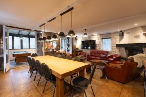 a living room with a table and chairs and a couch at Le Refuge des Isards - Chalet familial in Cauterets