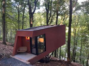 a tiny house in the woods with a window at Séneçon des bois 08 in La-Roche-en-Ardenne