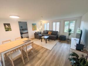a living room with a couch and a table at Apartment im Winkel in Reinach
