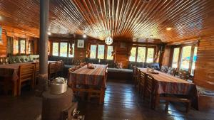 a dining room with tables and chairs and a clock at Phakding Camp One Lodge in Phakding