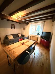 a living room with a table and a couch at Chez l'Alsacienne in Andlau