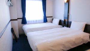 Giường trong phòng chung tại Toyoko Inn Shin-osaka Higashi-mikuni Ekimae