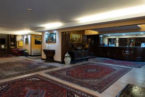 a lobby with two rugs on the floor and a table at Baia Di Ulisse Wellness & Spa in San Leone +103 photos