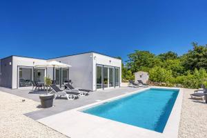a home with a swimming pool and a house at Villa Karolina by Villa Plus in Štokovci
