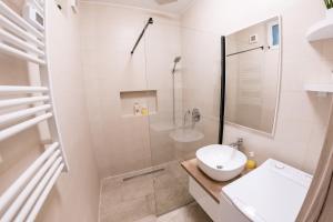 a bathroom with a shower and a toilet and a sink at DowntownKate in Debrecen +24 photos