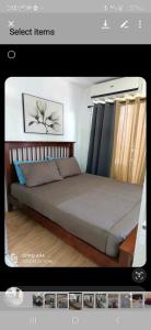 a picture of a bedroom with a bed in a room at Dream haven condo in Lapasan