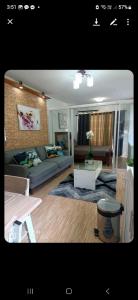 a living room with a couch and a table at Dream haven condo in Lapasan