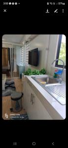 a kitchen with a sink and a counter top at Dream haven condo in Lapasan