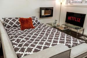 a living room with a couch and a television at Chic Suite - Long Stays - King Bed - Fireplace & WiFi in Edmonton +29 photos